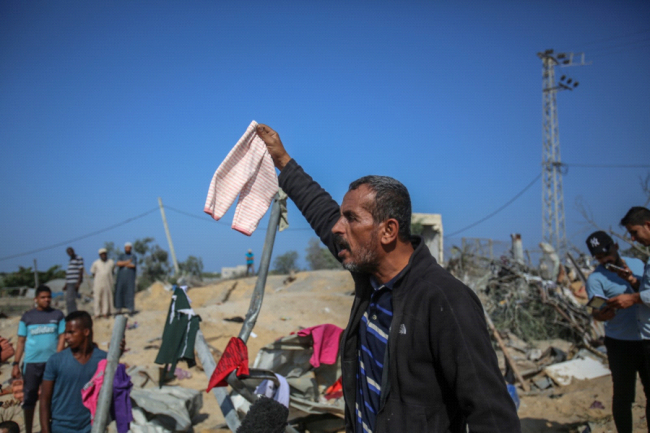 With ceasefire going into effect, Gaza mourns 34 slain Palestinians, some entire families